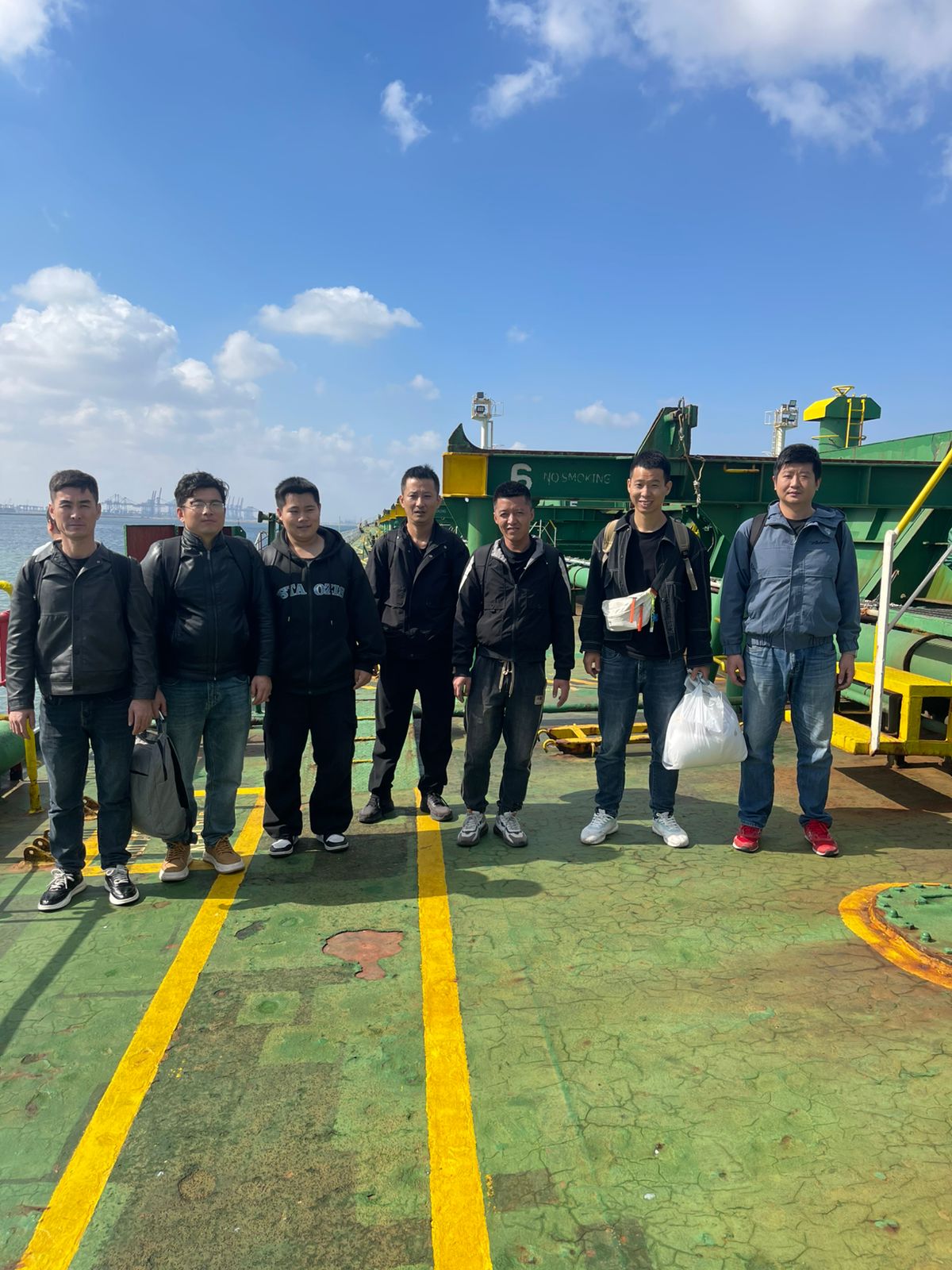 Crew change — seafarers on vessel deck at Port Said
